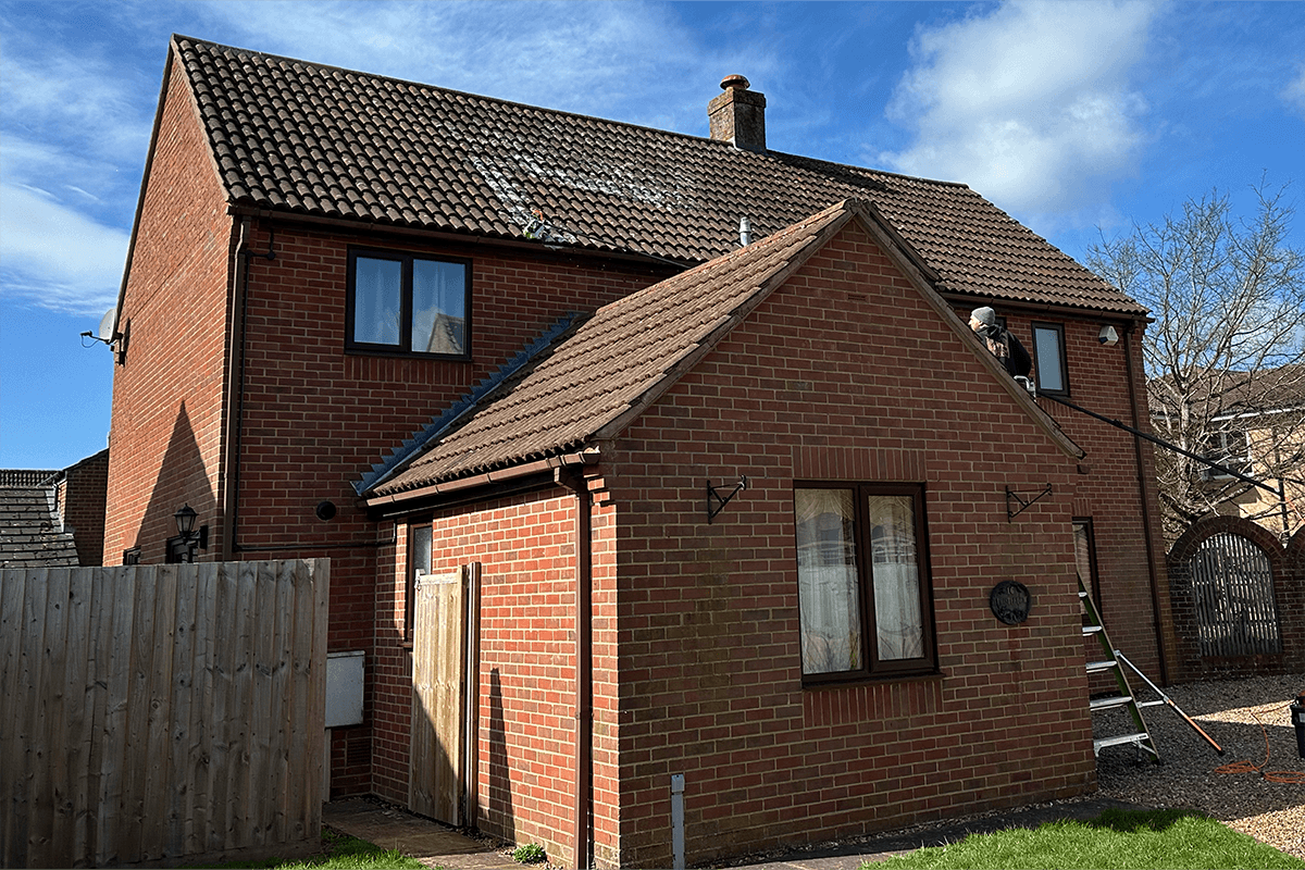 Biocide treatment being applied to roof tiles