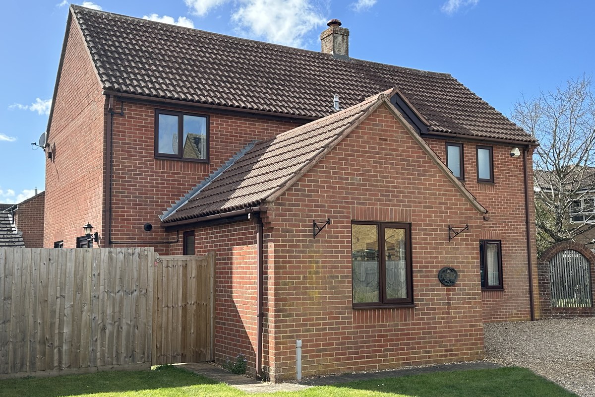 Roof one month after biocide treatment showing continued tile restoration